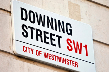 Downing street sign regarding stopping abuse and safer ageing with Hourglass charity